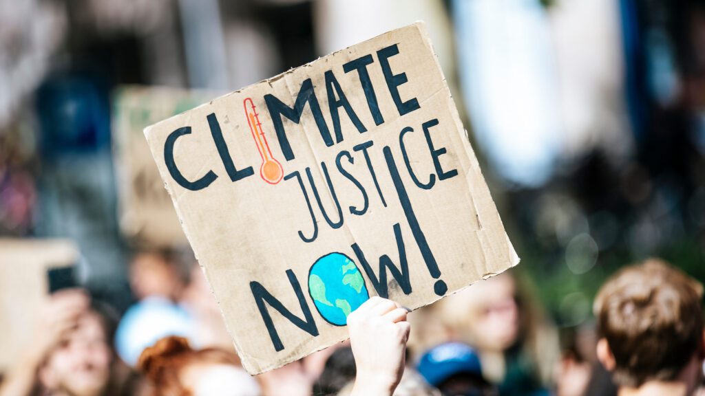 Markus Spiske/ Unsplash. Global climate change protesters hold signs